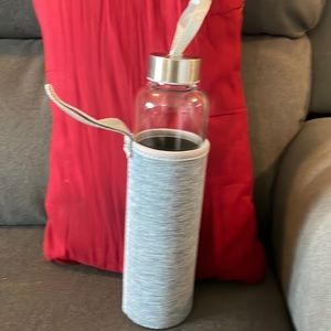 Glass water bottle with amethyst crystals.